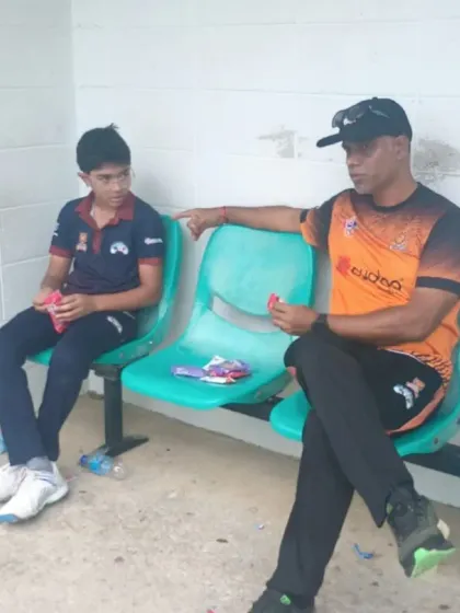 A one-on-one chat between a coach and a player during the Trinidad tour.