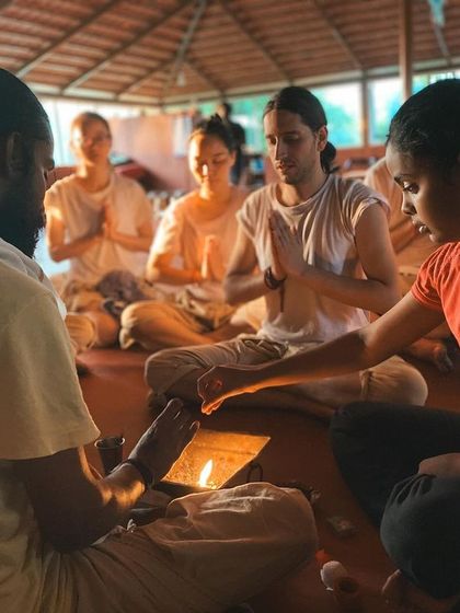 A student participates in a lamp lighting ceremony, a beautiful ritual symbolizing the dispelling of darkness and the welcoming of knowledge. Each flame represents the inner light we seek to awaken through our practice.