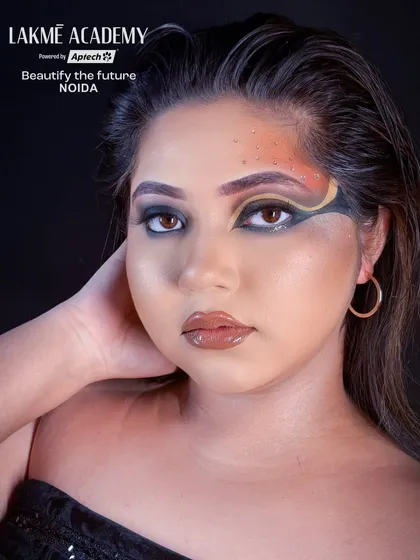 A confident portrait showing off a trendy Brazilian eye makeup look. This style is popular on social media and is a valuable skill for modern makeup artists.