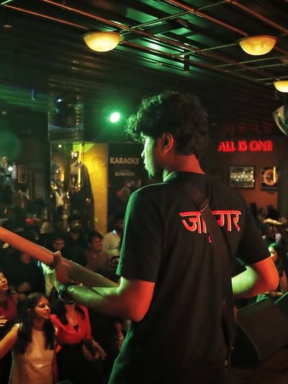 A view from behind the stage at Hard Rock Cafe. Our bassist is in the zone, providing the groove for a packed house.