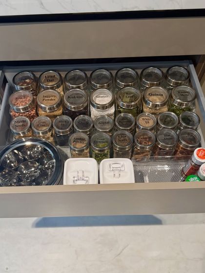 A deep dive into a spice drawer, where every jar is labeled and arranged for easy access. We also included a traditional masala dabba for frequently used spices, blending modern organization with classic convenience.