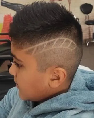 A close-up of a creative hair tattoo design, shaped like a feather. I can create all sorts of simple or intricate designs to make a haircut unique.