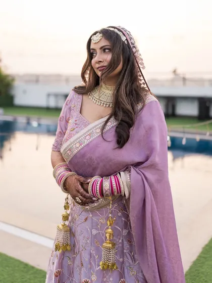 A beautiful three-quarter portrait of the bride, capturing the elegance of her posture and the soft light of dusk.
