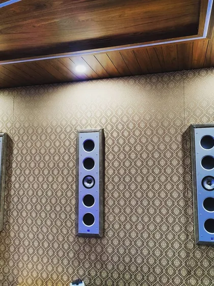 A detailed view of a KEF Ci-Series THX certified in-wall speaker installation. Mounting these reference speakers on a decoratively finished wall demonstrates our ability to achieve audiophile-grade sound without compromising room aesthetics. The precision engineering of these speakers ensures flawless audio reproduction.
