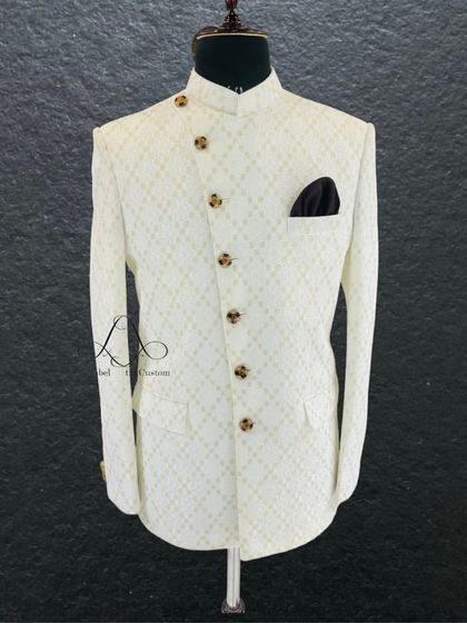 A classic white Jodhpuri bandhgala with a delicate self-pattern. This is the epitome of grace and is a perfect choice for daytime events or for a groom who wants a clean, royal look.