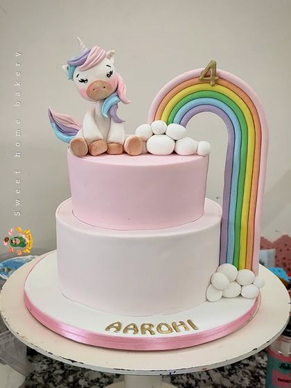 A unicorn and a rainbow, what could be more magical? This two-tiered cake for Aarohi's fourth birthday features a sweet, sleepy unicorn resting on a cloud, with a vibrant rainbow arching overhead. It's a timeless theme that always brings a smile.