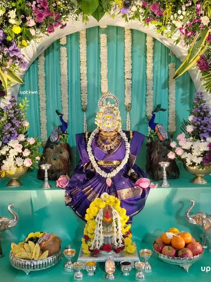 We have deep respect for religious traditions and create beautiful decor for festival's like Varamahalakshmi. This home setup features a stunning floral arch, traditional peacock and elephant figure's, and careful arrangement of all the pooja essential's to honor the occasion.