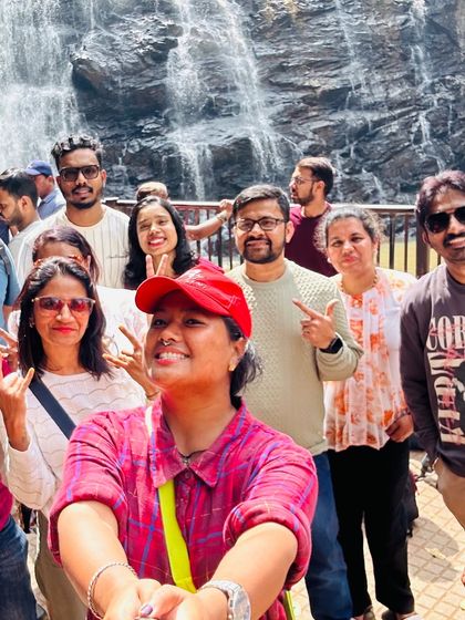 A happy selfie with the waterfall in the background. It's all about capturing those fun moments with new friends.