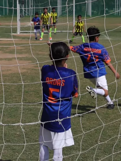 The view from behind the net as our player moves in for a shot. A crucial moment in the Gurgaon Youth League.