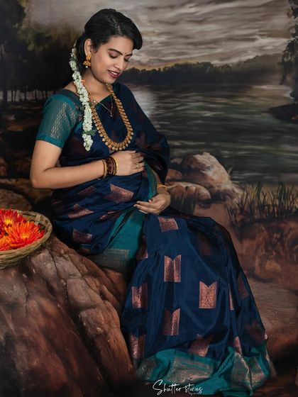 A gentle and loving pose, with the mom-to-be looking down at her bump, embodying the deep connection with her unborn child.