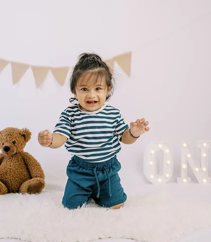Another happy moment from the same session, showing his excitement and energy as he celebrates turning one.