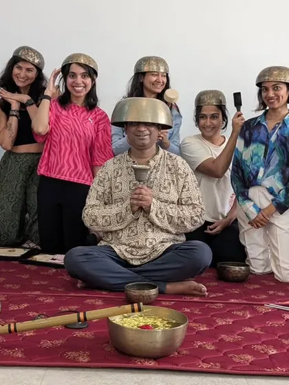 A fun and memorable moment with our sound healing graduates, who are playfully balancing singing bowls on their heads.