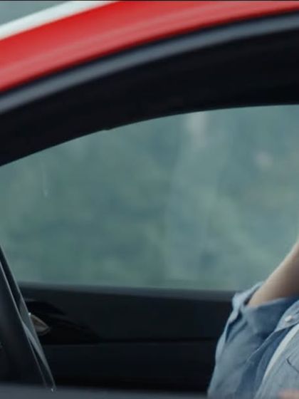 Another shot of the couple enjoying their drive. The simple, classic styling ensures the focus is on their connection and the driving experience.