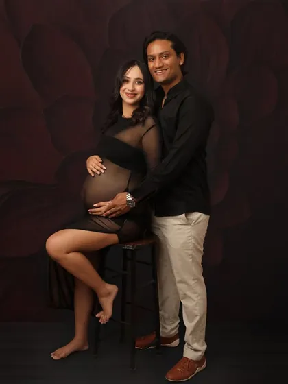 Two hearts, one love, and a little one on the way. This studio portrait focuses on the couple's loving embrace and their shared excitement for the journey ahead.