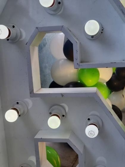 A close-up detail of the large, industrial-style marquee numbers used for the football party.