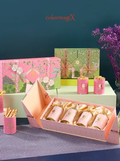 This beautiful pink and green floral hamper is designed for gifting wellness. The unique folding box reveals four satin-lined compartments holding jars of premium dry fruits and snacks.