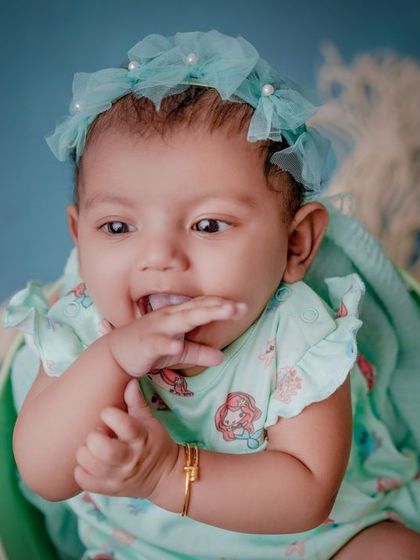 A bucket of cuteness. This three-month-old baby is full of expressions, and I love capturing them in these simple, colorful setups.