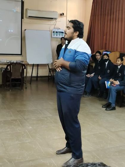 A trainer engages with students during a workshop, fostering an open and interactive learning environment where students feel comfortable asking questions.