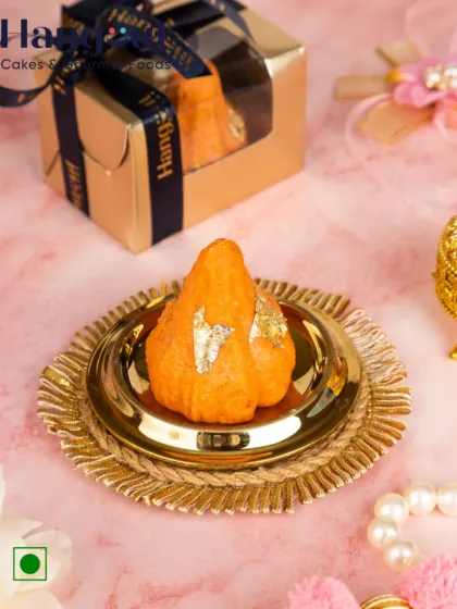 My Orange Mava Modaks are made with rich mawa and pure ingredients. Topped with edible gold foil, they are a delightful and traditional choice for prasad and gifting during Ganesh Chaturthi.