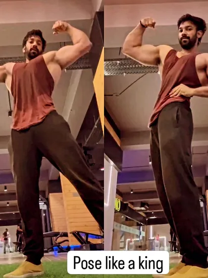 "Pose like a king." Confidence on stage is built through practice. Here, I'm demonstrating a front double biceps pose, a classic display of arm size and upper body width.