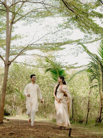 A playful chase through the woods. Dressed in traditional attire, their laughter and movement bring a lighthearted energy to this heritage-themed shoot.