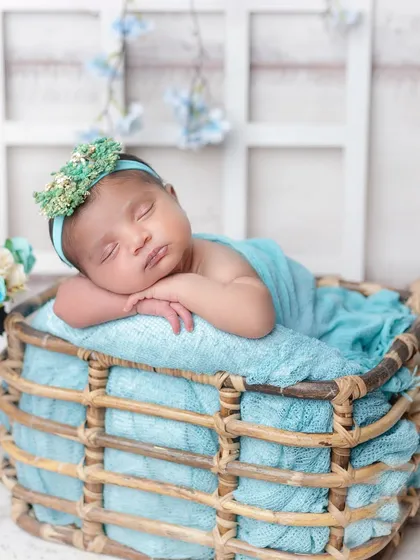 The peaceful sleep of a newborn is pure magic. I use soft wraps and cozy props like this basket to create classic, artistic portraits of your baby in their first few days.