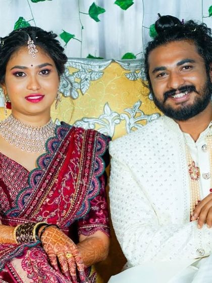 The happy couple. Nisha's sparkling choker adds a touch of modern glamour to their reception photos.