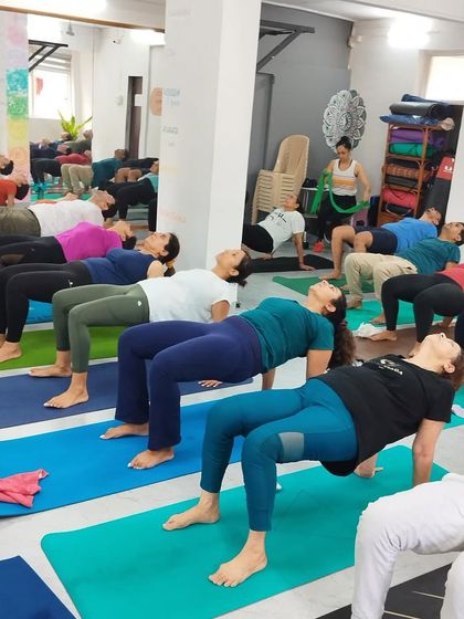 The collective energy of the class is palpable as students hold Purvottanasana, building strength and opening their hearts together.