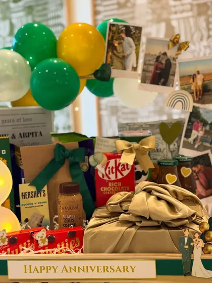 We included personal photographs in this anniversary hamper, creating a beautiful collage of the couple's memories. The Furoshiki-wrapped gift adds a touch of sustainable elegance.