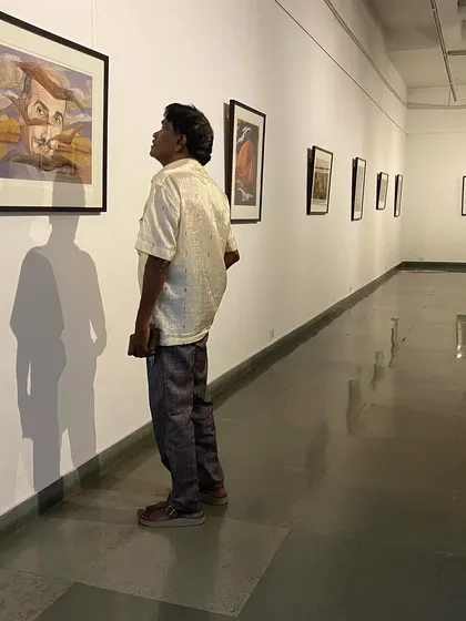 A visitor looking up at Jehangir Sabavala's 'Mirror Image' serigraph.