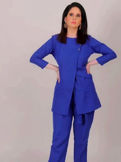 A full-body shot showcasing the chic blue co-ord set, complemented by the subtle makeup.