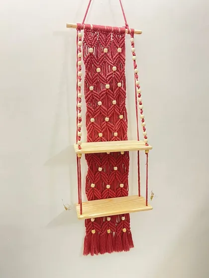 For those who need a bit more storage, I created this two-tier macrame shelf in a striking red. The design includes a detailed macrame back panel with wooden bead accents, adding both function and a vibrant decorative element to your wall.