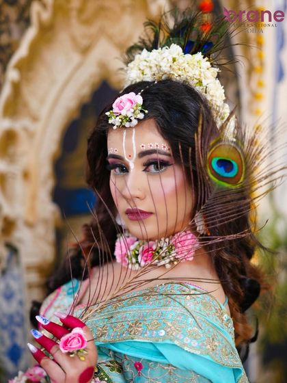 The peacock feather adds a symbolic and beautiful touch to this Radha-inspired fantasy look.