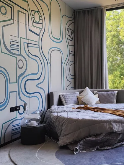 In this bedroom, the art refuses to be contained. The hand-painted line art flows seamlessly from the wall across the wardrobe doors, integrating the artwork directly into the room's architecture and creating a cohesive, calming environment.