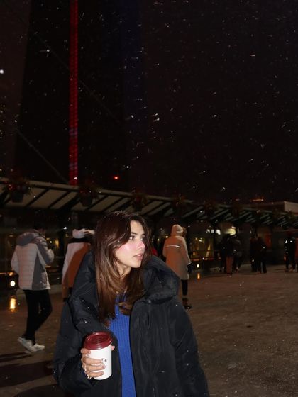 A close-up shot capturing the snowflakes falling around me, creating a dreamy, atmospheric portrait.