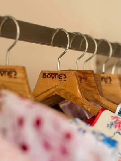 Another view of my hangers, holding a variety of colorful printed dresses ready for their new homes.