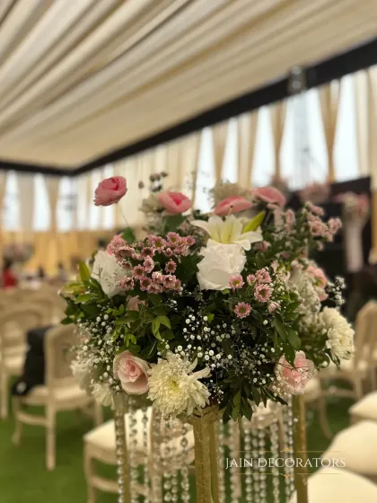 A delicate and airy floral arrangement. I used a mix of roses, baby's breath, and other soft blooms to create this romantic centerpiece for a guest table.