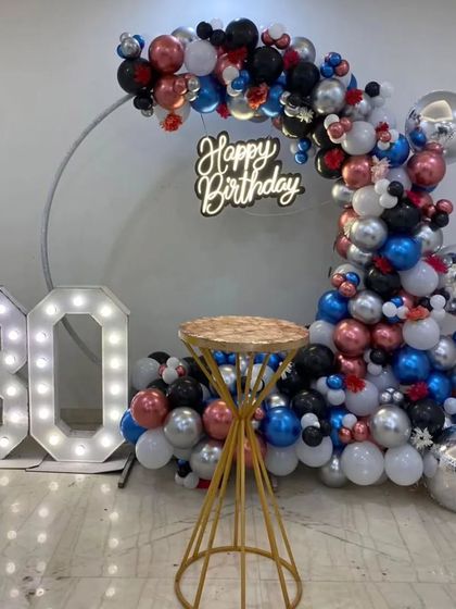 The complete 30th birthday setup, showing the C-shaped balloon arch and light-up numbers.