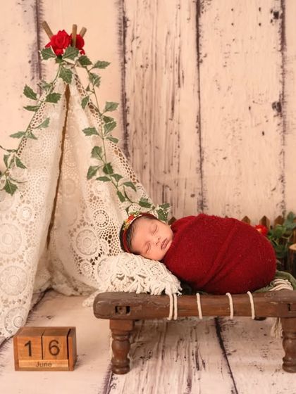 For the adventurous family, this little camper theme with a lace teepee, rustic wood, and pops of red is a wonderfully unique and charming choice.