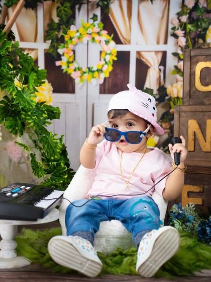 This little rockstar has all the style and attitude. The cool sunglasses, headphones, and keyboard make for a fun and modern musical-themed shoot.