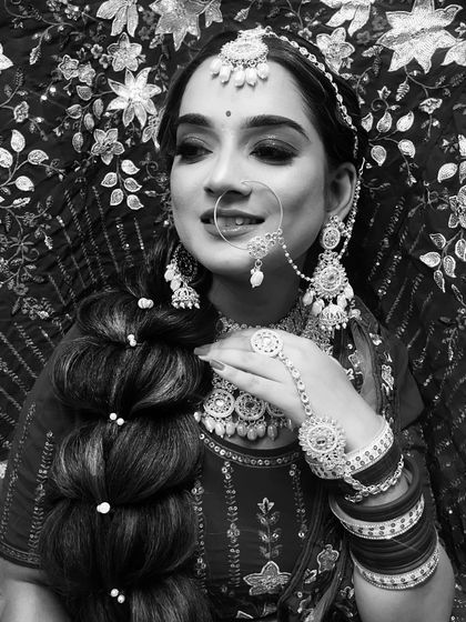 A smiling black and white portrait that captures the joy of the bride, showing that great makeup translates beautifully even without color.