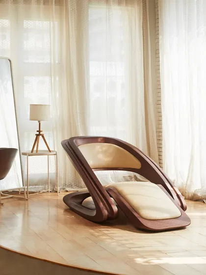 The FusionWAVE Lounge Chair in a serene, sunlit room. Its sculptural form makes it a centerpiece, proving that functional furniture can also be a work of art.
