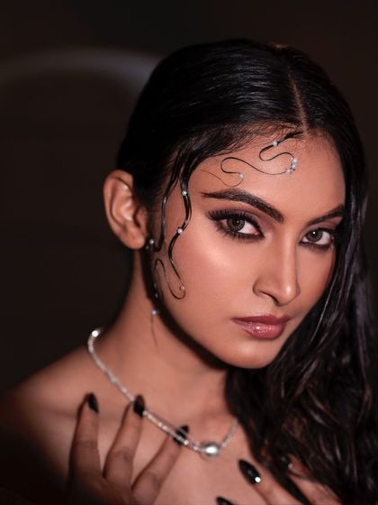 A close-up from the wet-look series, this shot is all about texture and mood. The dramatic lighting and the model's intense gaze create a captivating and artistic portrait.