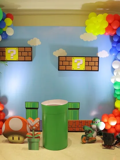 A wide shot of the Super Mario party stage, showing the full backdrop with game scenery, props, and a colorful balloon arch. This demonstrates how I can transform a large space into the Mushroom Kingdom.