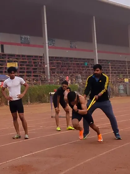 Correcting an athlete's form during a resistance band start, ensuring maximum power output.