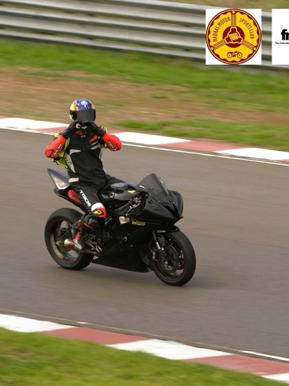 A rider celebrating a great session on the track. The feeling of accomplishment after a full day of riding is incredible.
