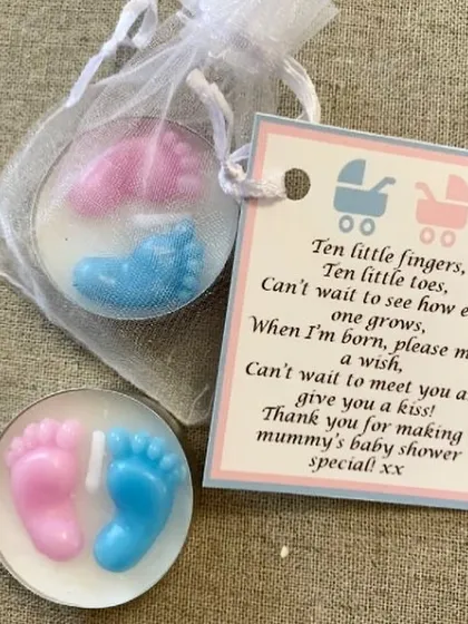 A simple and sweet baby shower favor idea. These tea light candles with pink and blue baby feet come in a small net bag with a personalized thank you note.