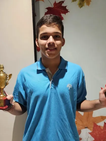 Vikrant Negi proudly holding the trophy and medal his team won. His leadership was instrumental in their success.