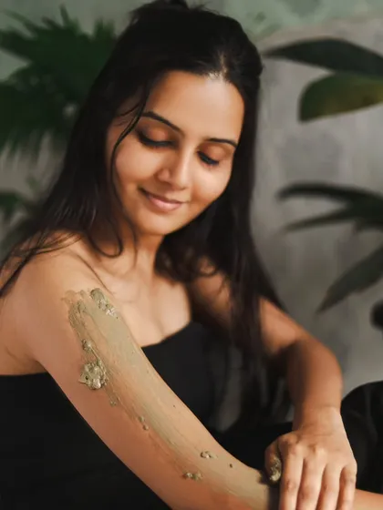 A close-up showing the texture of the clay on the skin. This kind of detail shot is great for telling a story and for commercial beauty photography.