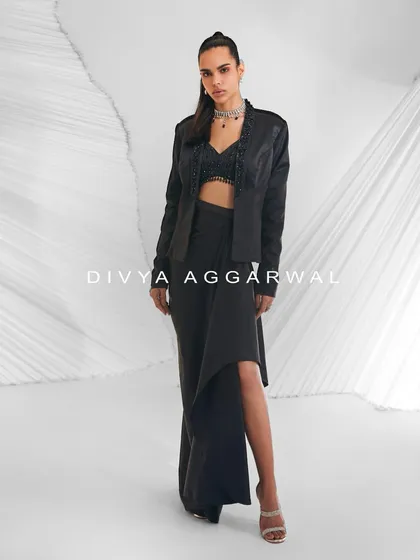A stylized shot of the Debro Jacket Set, offering a fuss-free fusion wear option with its sleek black blazer and draped skirt.